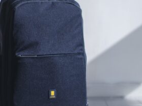 Minimalist backpack and tech gear laid out for a weight-optimized digital nomad carry-on setup